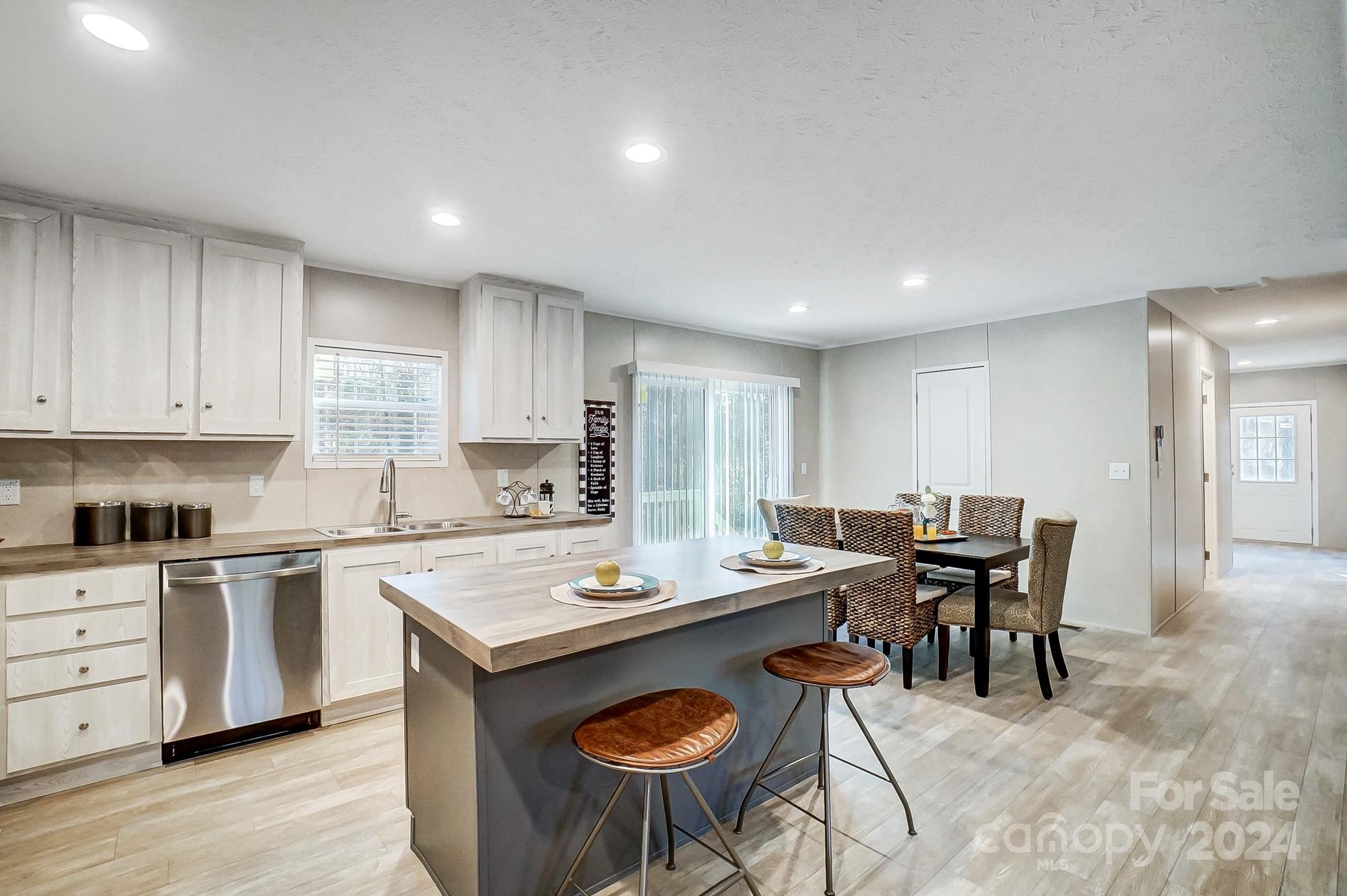 1860 Bascom Lane Midland, NC 28107 - Photo 3 of 27 a open kitchen with stainless steel appliances granite countertop a stove a sink a table and chairs