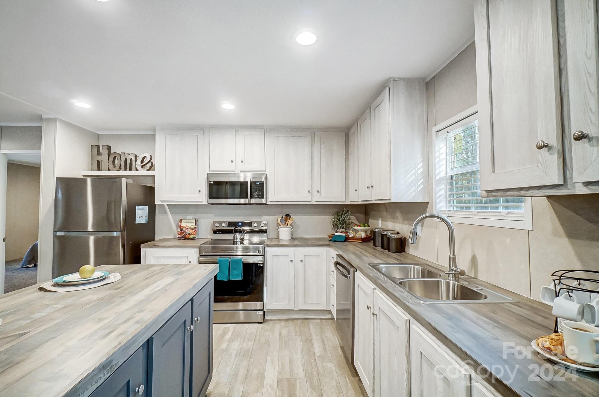 1860 Bascom Lane Midland, NC 28107 - Photo 4 of 27 a kitchen with stainless steel appliances granite countertop a sink stove and refrigerator