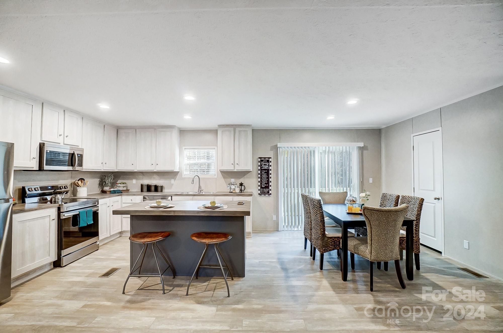 1860 Bascom Lane Midland, NC 28107 - Photo 7 of 27 a view of a dining room with furniture and wooden floor