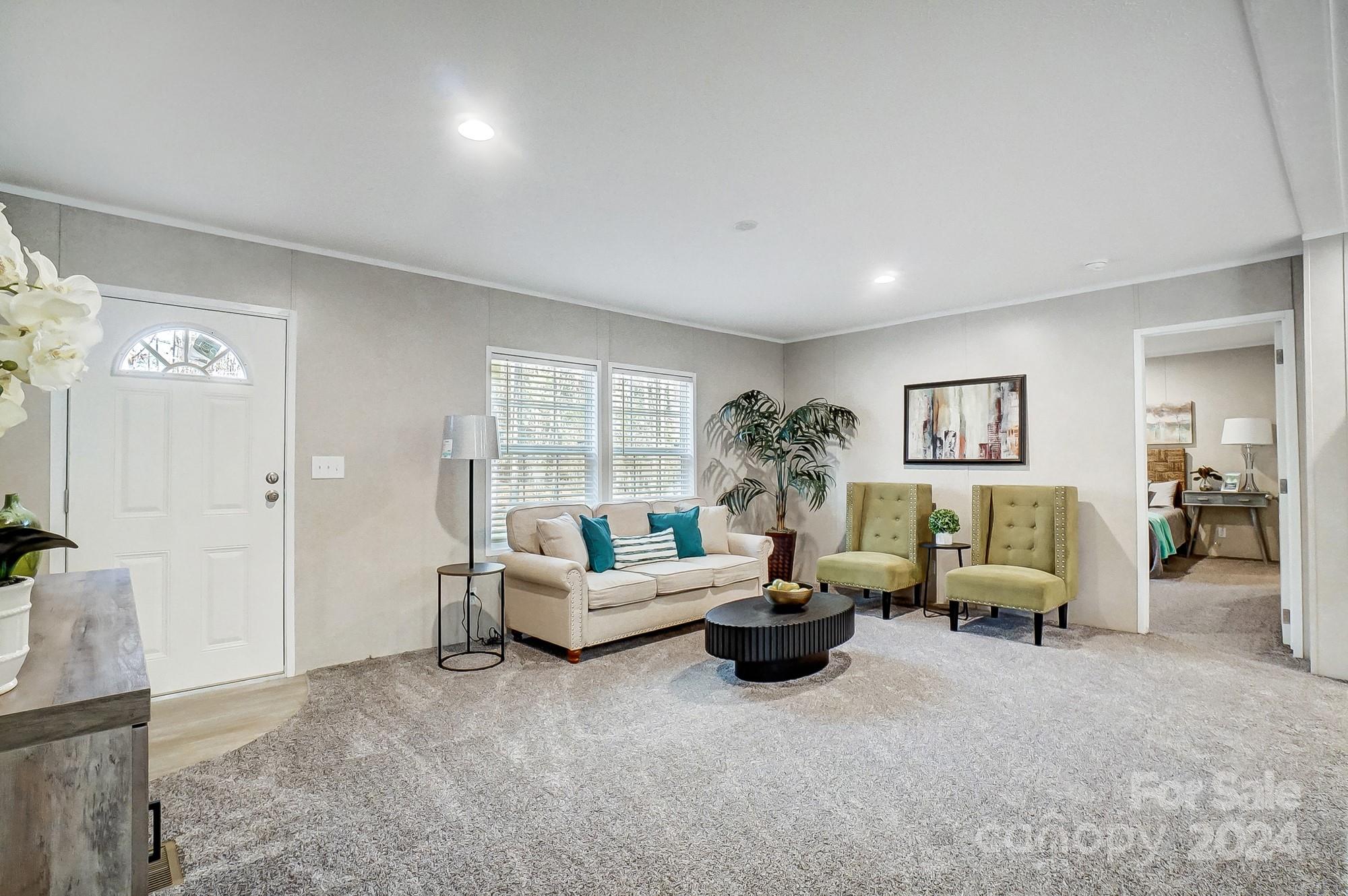 1860 Bascom Lane Midland, NC 28107 - Photo 10 of 27 a living room with furniture and a potted plant