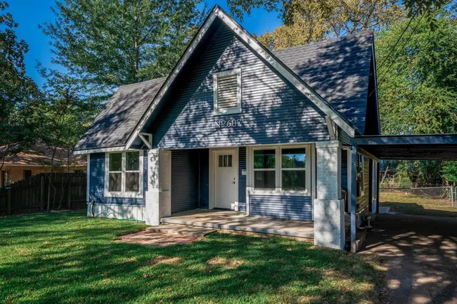 a front view of a house with a yard and porch