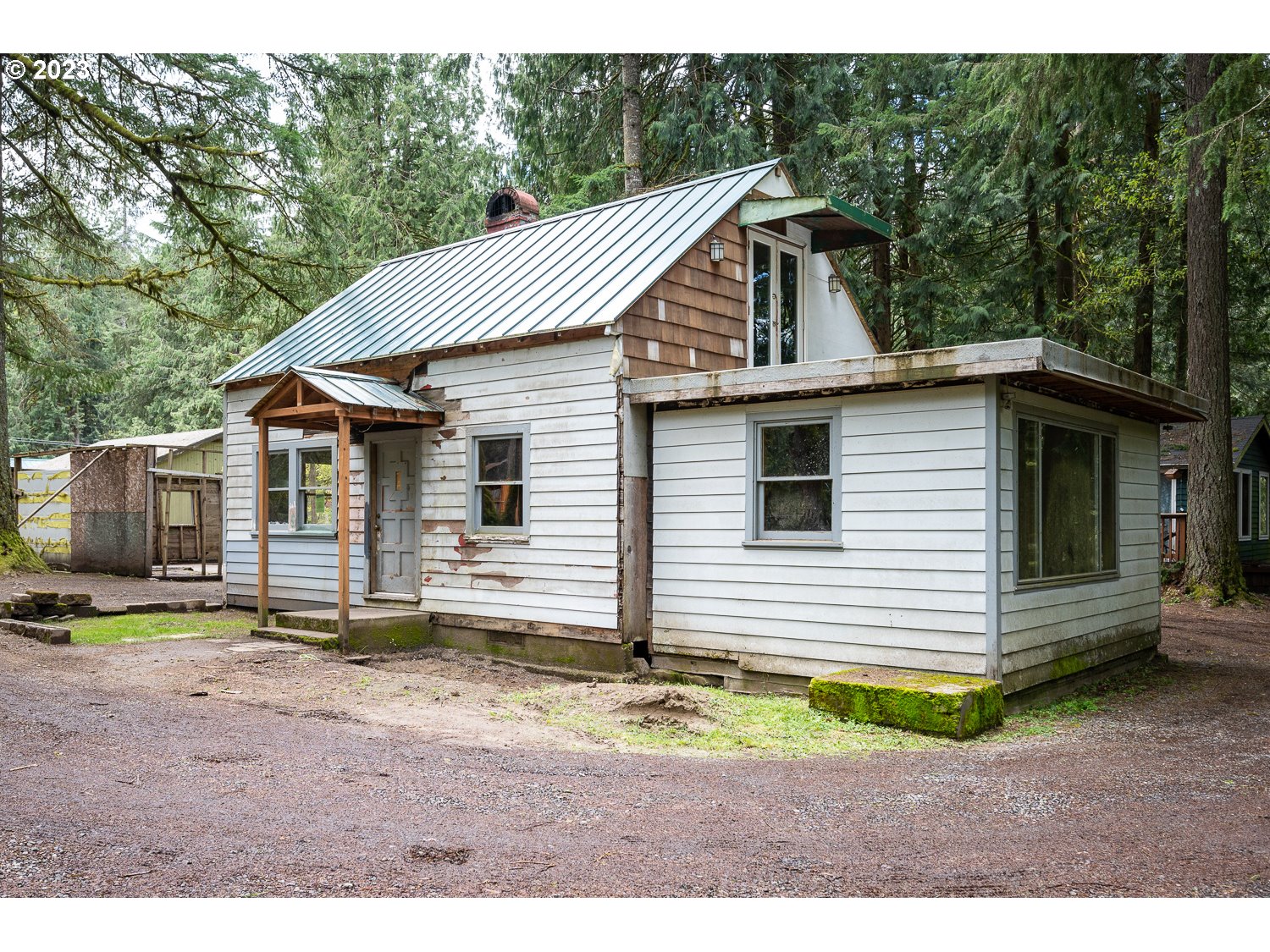 59191 Southeast Chalet Place Sandy, OR 97055 - Photo 14 of 25 a view of a house with backyard and trees in the background
