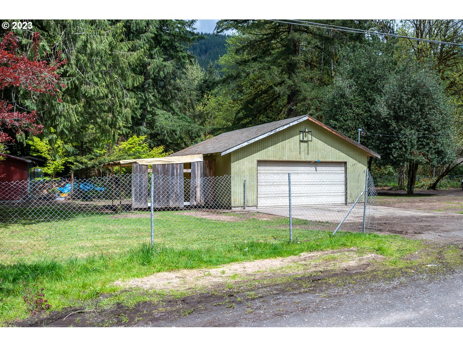 59191 Southeast Chalet Place Sandy, OR 97055 - Photo 16 of 25 a front view of a house with a yard and garage
