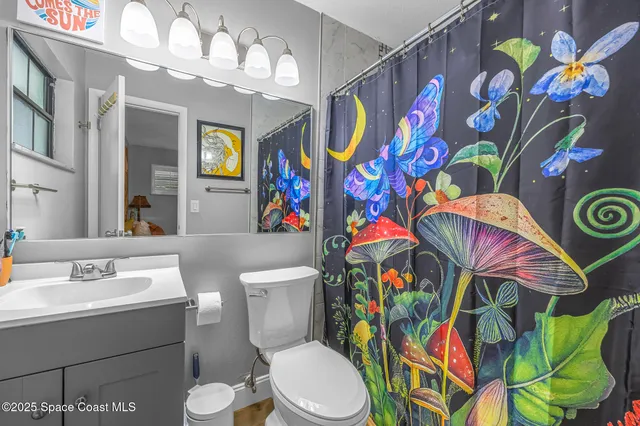 a bathroom with a sink mirror vanity and toilet