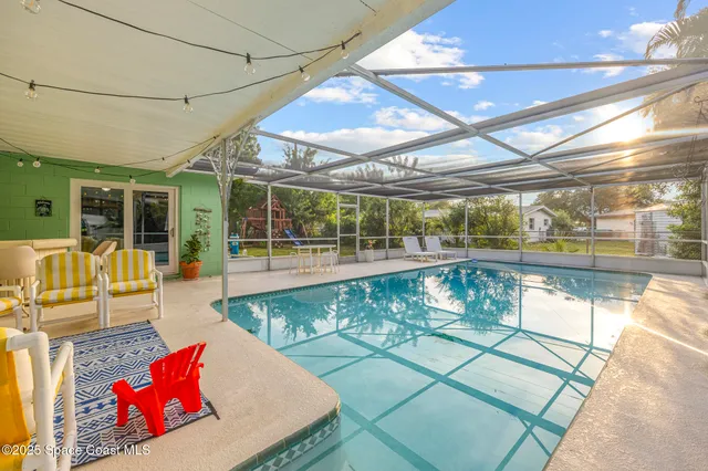 a view of a living room and kitchen with a large window