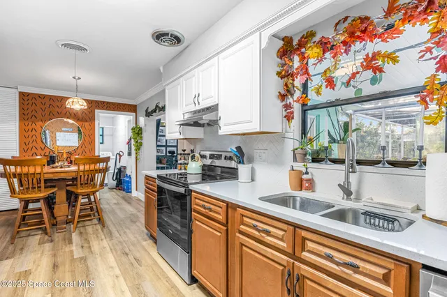 a kitchen with stainless steel appliances granite countertop sink stove top oven and cabinets