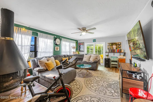 a living room with furniture fireplace and flat screen tv