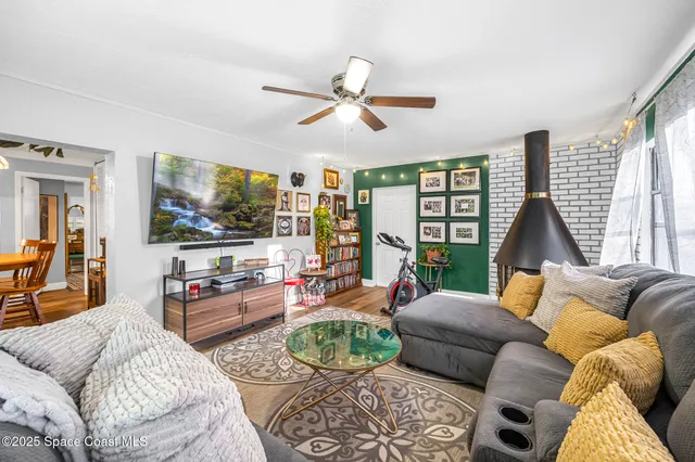 a living room with furniture large window and flat screen tv
