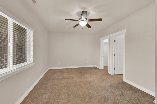 1823 North Crest Road Saratoga Springs, UT 84045 - Photo 10 of 18 Spare room featuring ceiling fan and light carpet