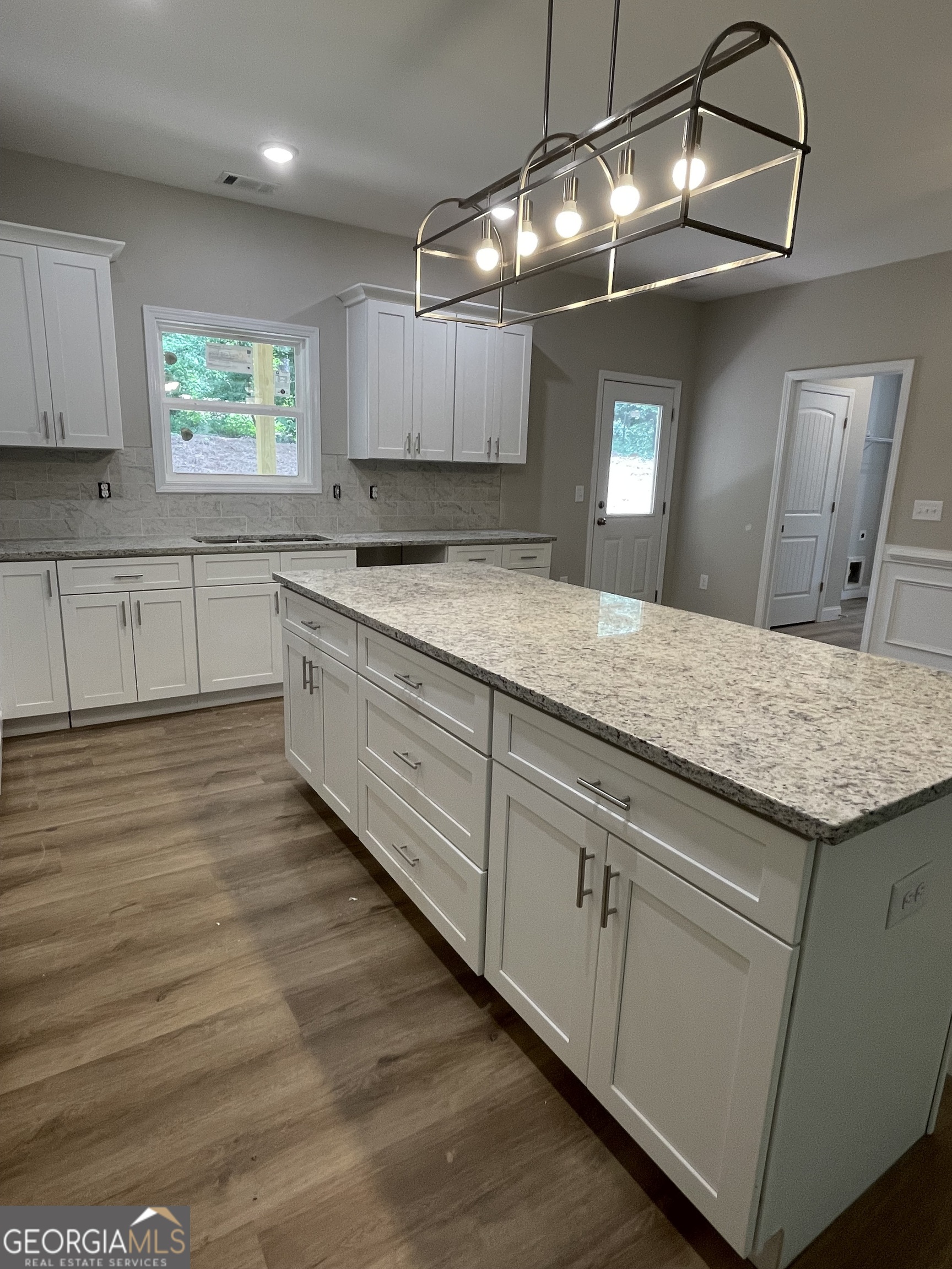 115 Drues Road Bowdon, GA 30108 - Photo 6 of 13 a kitchen with granite countertop white cabinets and white appliances