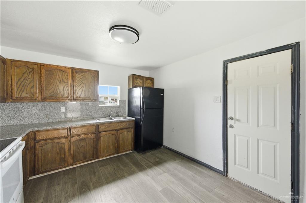 715 East Rusty Drive Pharr, TX 78577 - Photo 6 of 14 a kitchen with stainless steel appliances granite countertop a refrigerator and a sink