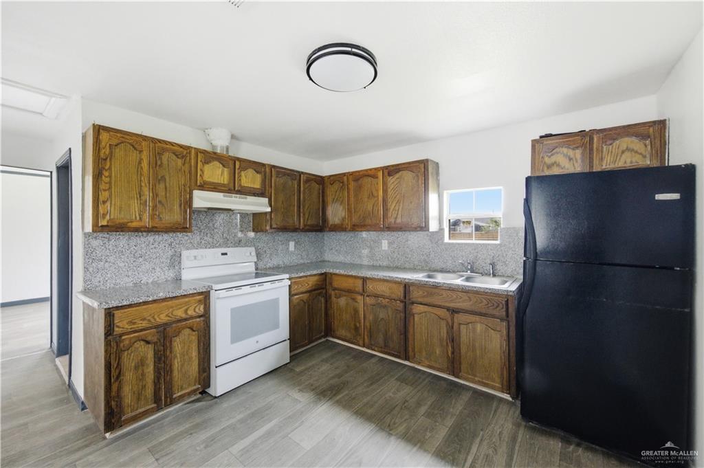 715 East Rusty Drive Pharr, TX 78577 - Photo 7 of 14 a kitchen with a sink cabinets and appliances