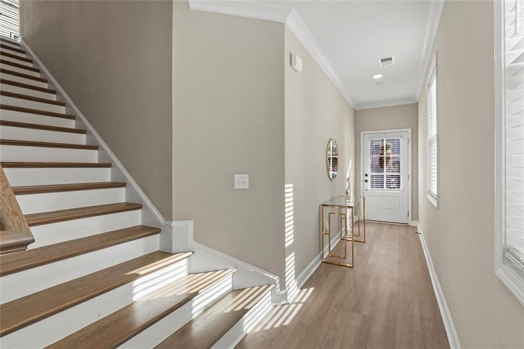 3739 Silvery Way Powder Springs, GA 30127 - Photo 12 of 28 a view of a hallway with wooden floor and entryway