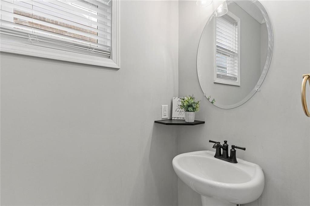 3739 Silvery Way Powder Springs, GA 30127 - Photo 13 of 28 a bathroom with a sink and a mirror