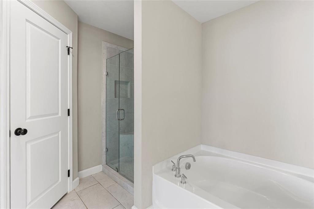 3739 Silvery Way Powder Springs, GA 30127 - Photo 17 of 28 a bathroom with a bathtub