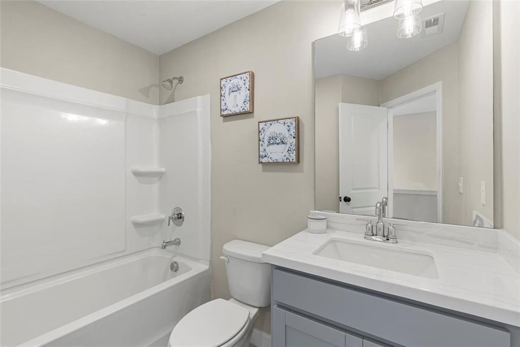 3739 Silvery Way Powder Springs, GA 30127 - Photo 18 of 28 a bathroom with a sink toilet and a bathtub