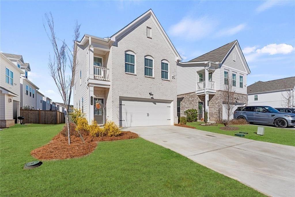 3739 Silvery Way Powder Springs, GA 30127 - Photo 2 of 28 a front view of a house with a yard and garage
