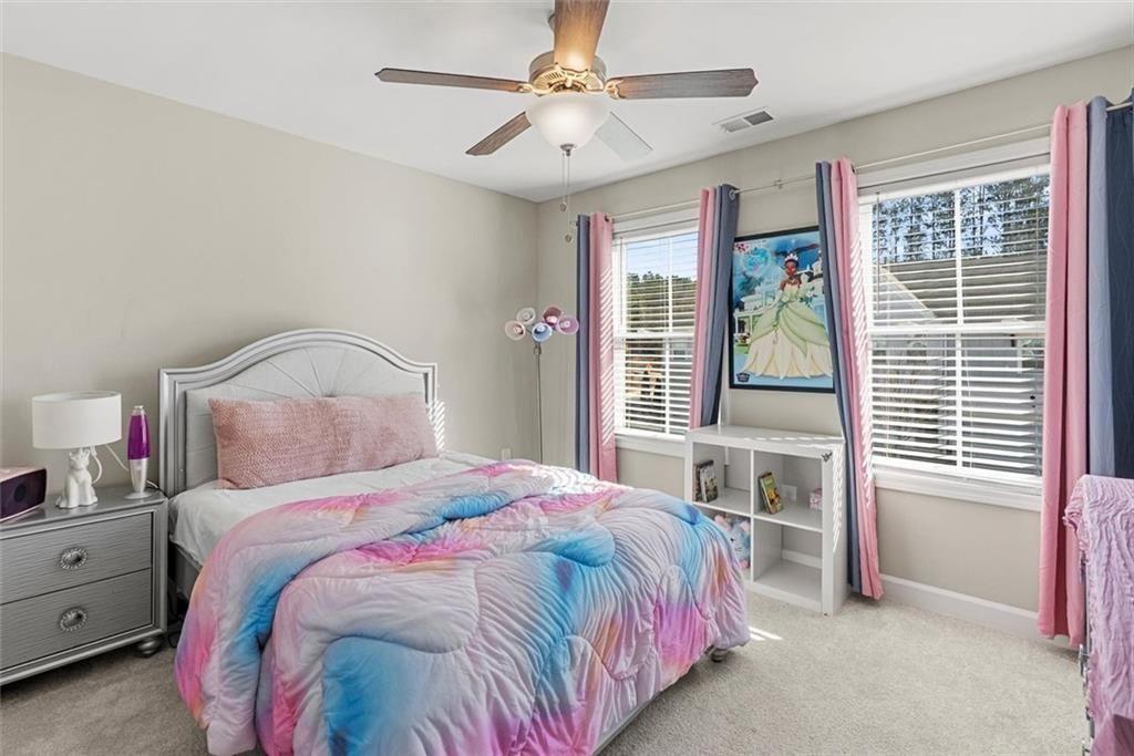 3739 Silvery Way Powder Springs, GA 30127 - Photo 21 of 28 a bedroom with a bed dresser and a window