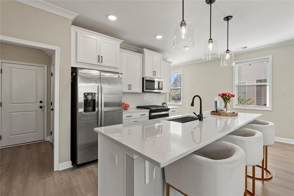 3739 Silvery Way Powder Springs, GA 30127 - Photo 6 of 28 a kitchen with refrigerator and wooden floor