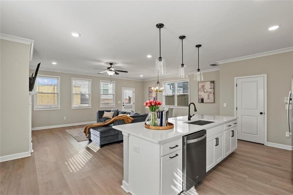 3739 Silvery Way Powder Springs, GA 30127 - Photo 7 of 28 a view of a kitchen counter space a sink wooden floor and windows