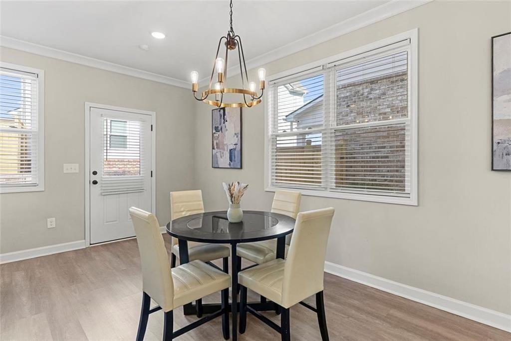3739 Silvery Way Powder Springs, GA 30127 - Photo 10 of 28 a view of a dining room with furniture wooden floor and chandelier