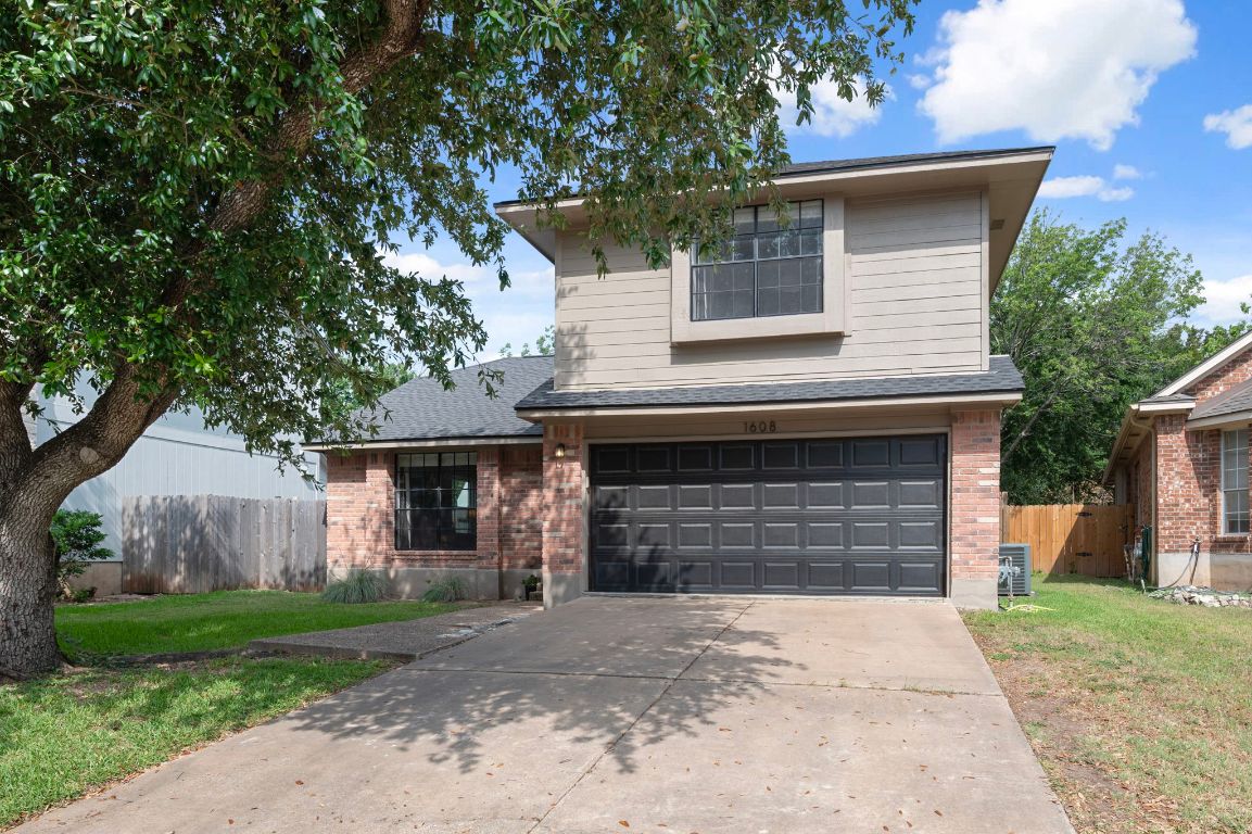 1608 White Oak Loop Round Rock, TX 78681 - Photo 1 of 1 a front view of a house with a yard and garage