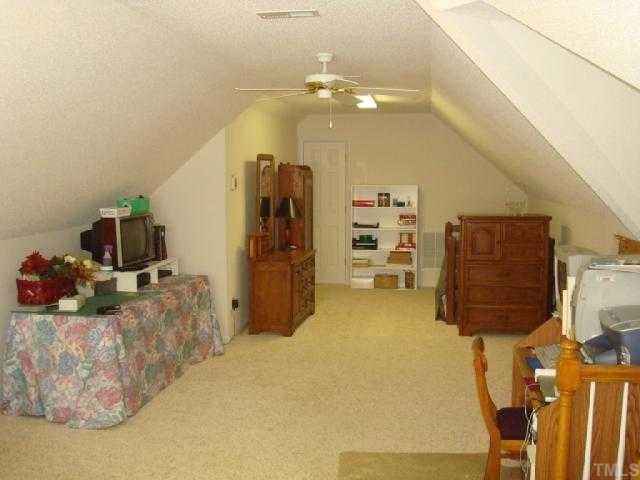 98 Line Drive Raleigh, NC 27603 - Photo 11 of 12 Huge bonus room is 33' long. Great location for storage, home business or guest room.