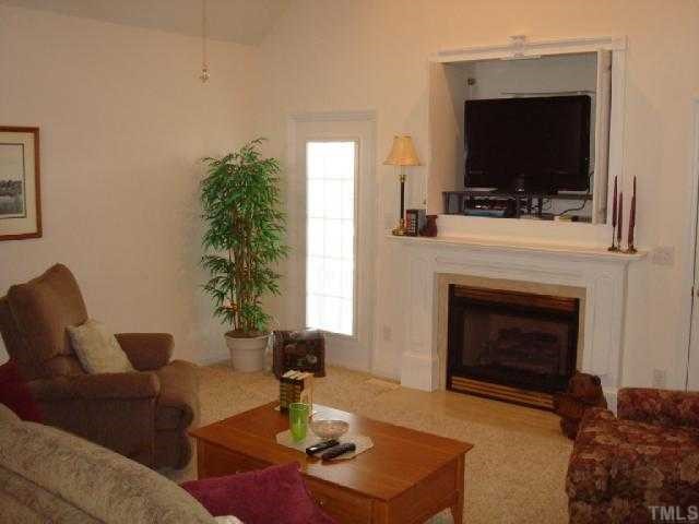 98 Line Drive Raleigh, NC 27603 - Photo 5 of 12 Living room with gas log fireplace.