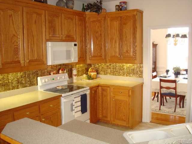 98 Line Drive Raleigh, NC 27603 - Photo 6 of 12 Kitchen with under counter lighting and view into dining room.