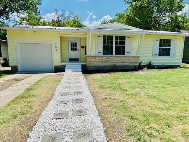 a front view of a house with yard