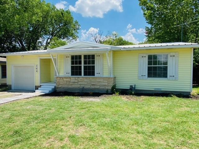 704 Nash Street Rockwall, TX 75087 - Photo 12 of 15 a view of a house with a garden