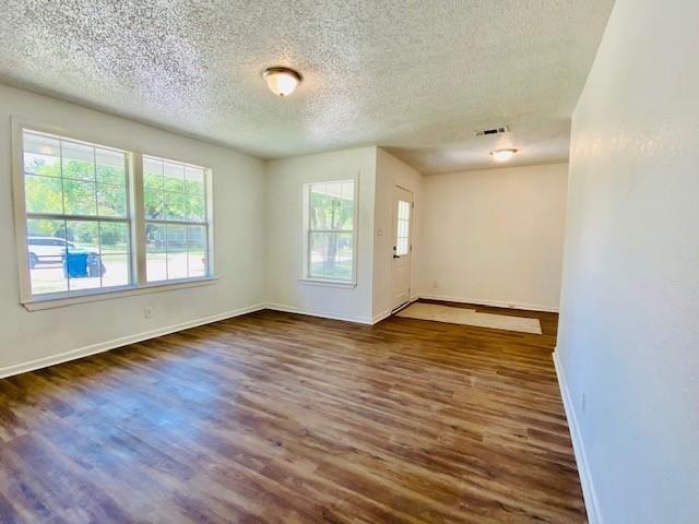 704 Nash Street Rockwall, TX 75087 - Photo 3 of 15 an empty room with wooden floor and windows