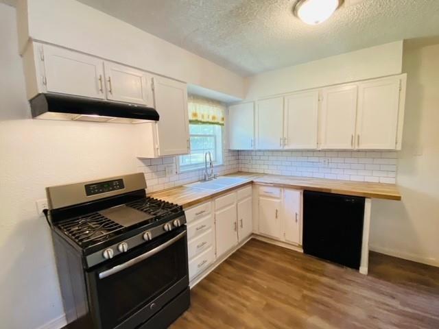 704 Nash Street Rockwall, TX 75087 - Photo 5 of 15 a kitchen with granite countertop a stove and a sink