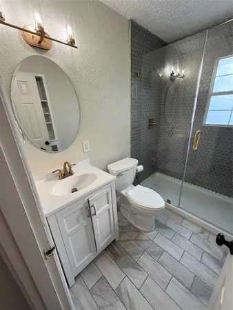 a bathroom with a sink a toilet and shower