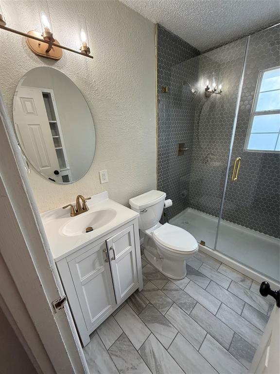 704 Nash Street Rockwall, TX 75087 - Photo 10 of 15 a bathroom with a sink a toilet and shower