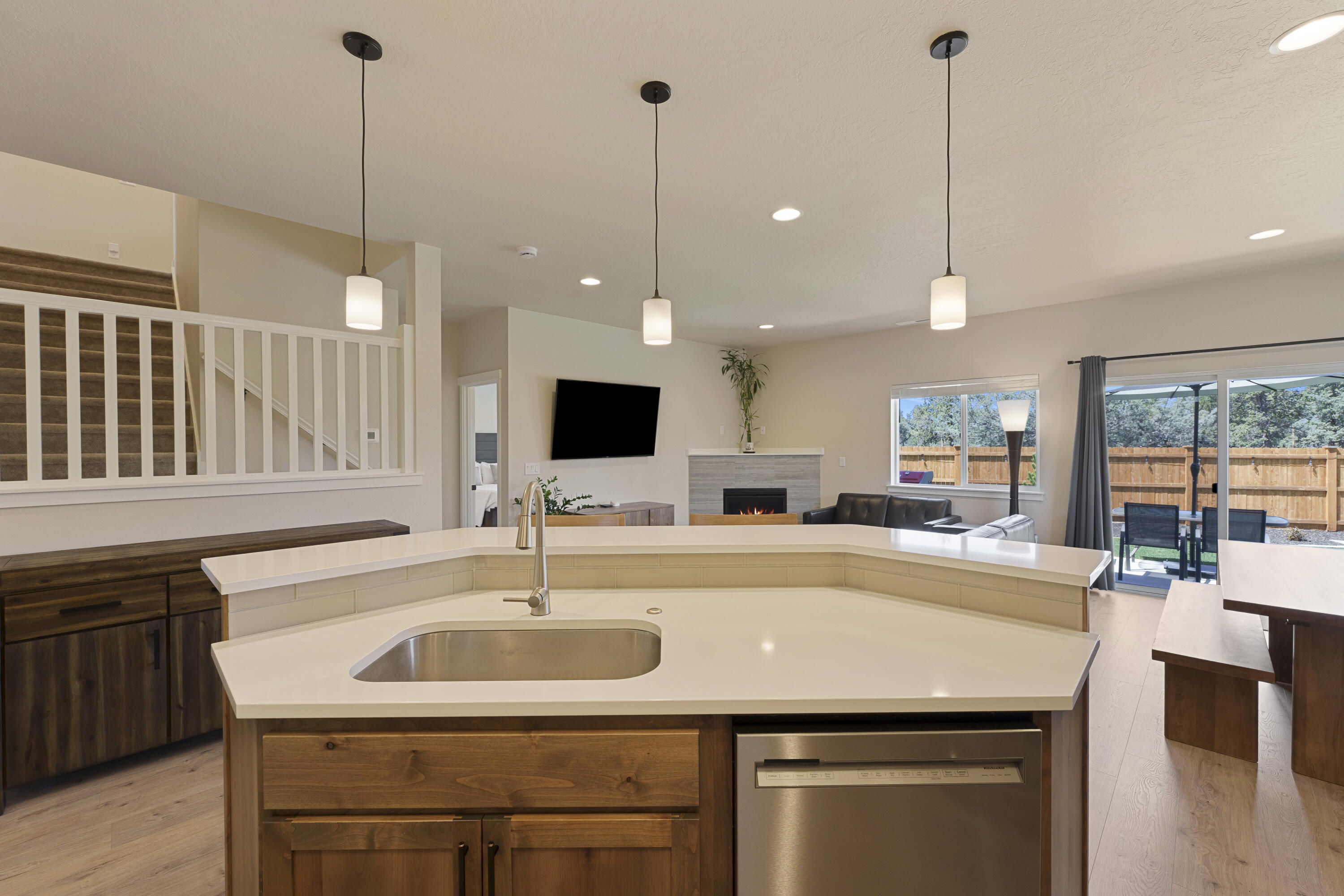 4999 Southwest Yew Place Redmond, OR 97756 - Photo 13 of 50 a kitchen with a sink a center island and cabinets