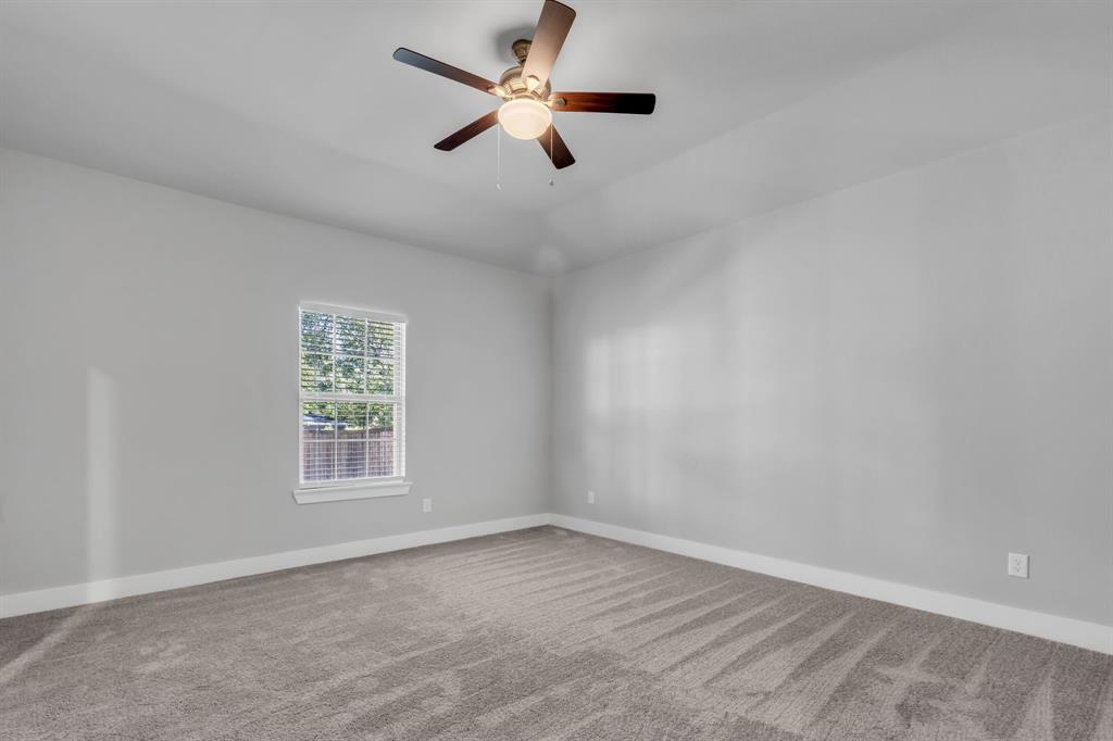 121 West Morton Street Denison, TX 75021 - Photo 16 of 28 an empty room with a window and a fan