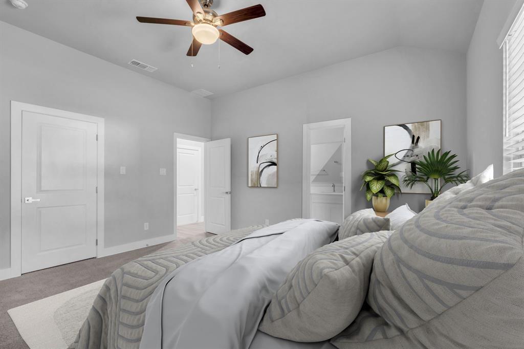 121 West Morton Street Denison, TX 75021 - Photo 17 of 28 a bedroom with a bed and a chandelier