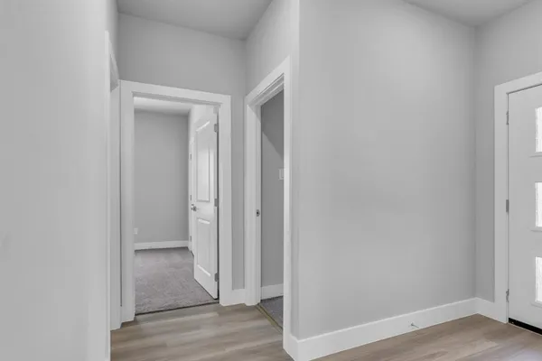 a view of a hallway with wooden floor