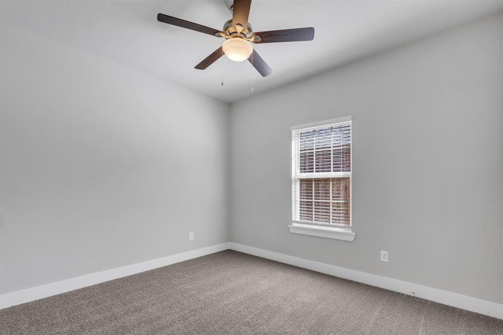 121 West Morton Street Denison, TX 75021 - Photo 22 of 28 an empty room with windows and fan