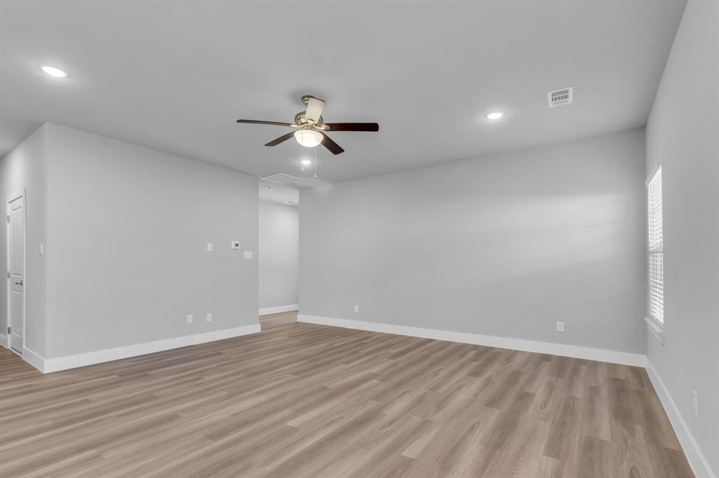 121 West Morton Street Denison, TX 75021 - Photo 10 of 28 wooden floor in an empty room with a window
