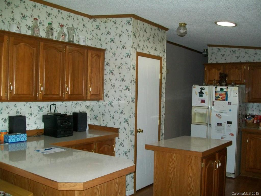 621 Sandifer Road York, SC 29745 - Photo 17 of 22 a kitchen with stainless steel appliances granite countertop a sink a refrigerator and a stove