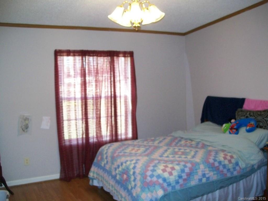 621 Sandifer Road York, SC 29745 - Photo 19 of 22 a bedroom with a bed and a chandelier