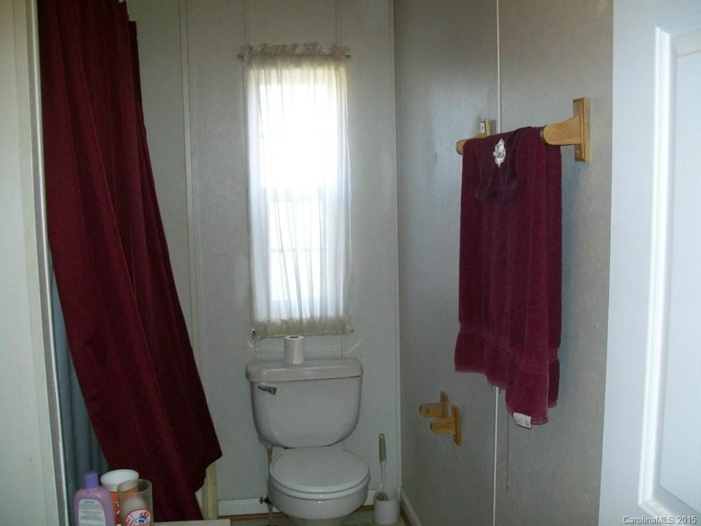 621 Sandifer Road York, SC 29745 - Photo 22 of 22 a bathroom with a toilet and a shower curtain