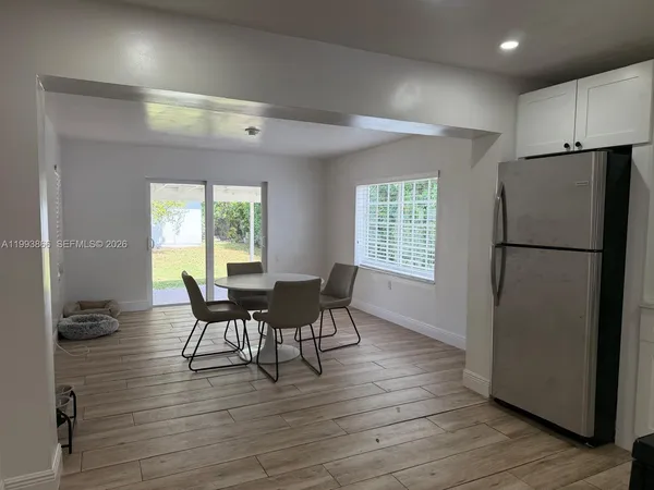 a view of a dining room with furniture and a wooden floor