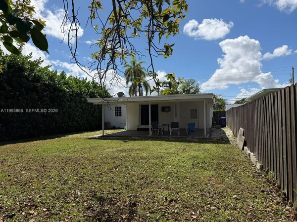 a view of a house with a yard and garage