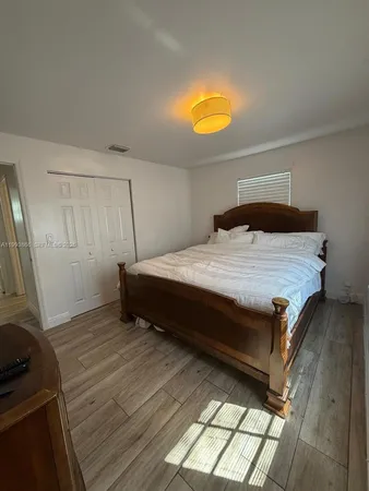 a bed sitting in a room next to a window