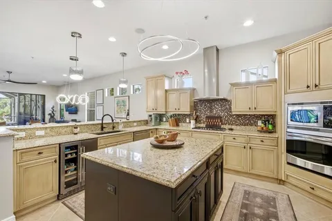 a kitchen with stainless steel appliances granite countertop a sink stove and cabinets