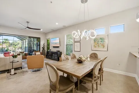 a view of a dining room with furniture and a large window