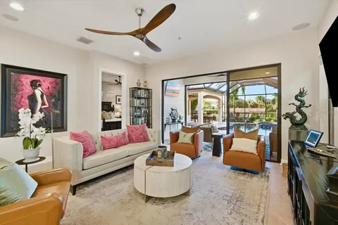 a living room with furniture and floor to ceiling window